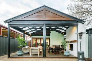 a pavilion with a table and chairs on a patio at Essex Cottage with garden, 2BR, near Adelaide Showground in Wayville