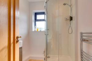 a shower stall in a bathroom with a window at 25A City Road · Luxury City centre townhouse with courtyard Pass the Keys in Cambridge