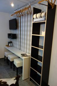 a room with a desk and a table and shelves at Chiemgau-ROOM, helles Souterrain, eigene Terrasse in Riedering +14 photos