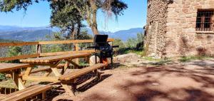 a picnic table with a laptop sitting on top of it at Mas Morrenyà - Casa rural in Sant Jaume de Llierca