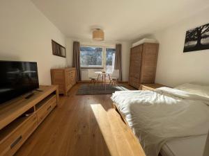 a bedroom with a bed and a flat screen tv at Ferienwohnung Rendl-Blick in Sankt Anton am Arlberg