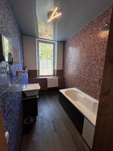 a large bathroom with a tub and a sink at Gemütliche Apartments AMT in Plauen +41 photos