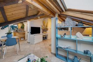a living room with blue shelves and a table at Mansarda Sotto Le Stelle in Savona