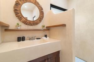 a bathroom with a sink and a mirror at Lovely Villa 1-BR Villa Miguel in Chemuyil
