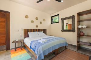 a bedroom with a bed and a mirror in it at Lovely Villa 1-BR Villa Miguel in Chemuyil