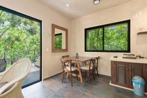 a kitchen and dining room with a table and chairs at Lovely Villa 1-BR Villa Miguel in Chemuyil