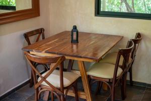 a wooden table with chairs and a bottle on it at Lovely Villa 1-BR Villa Miguel in Chemuyil
