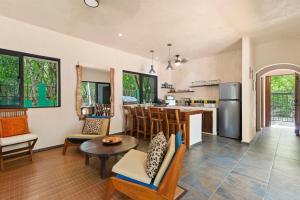 an open kitchen and living room with a table and chairs at Lovely Villa 1-BR Villa Miguel in Chemuyil