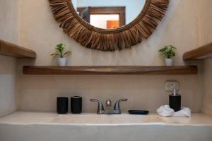 a bathroom sink with a large mirror above it at Lovely Villa 1-BR Villa Miguel in Chemuyil +37 photos