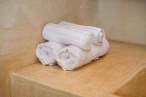 two towels sitting on top of a wooden table at Lovely Villa 1-BR Villa Miguel in Chemuyil