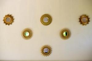 a group of gold mirrors on a wall at Lovely Villa 1-BR Villa Miguel in Chemuyil