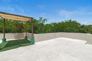 a large patio with a gazebo on a roof at Lovely Villa 1-BR Villa Miguel in Chemuyil