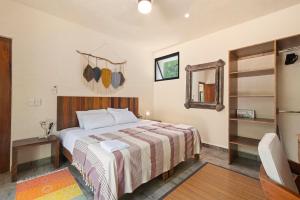a hotel room with a bed and a mirror at Lovely Villa 1-BR Villa Miguel in Chemuyil