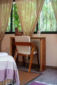 a desk with a chair next to a window at Lovely Villa 1-BR Villa Miguel in Chemuyil