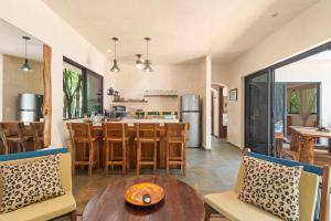 an open kitchen and dining room with a table and chairs at Lovely Villa 1-BR Villa Miguel in Chemuyil