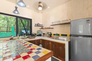 a kitchen with a refrigerator and a counter top at Lovely Villa 1-BR Villa Miguel in Chemuyil