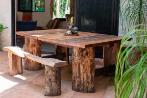 a wooden table and bench with a wooden table and chairs at Lovely Villa 1-BR Villa Miguel in Chemuyil