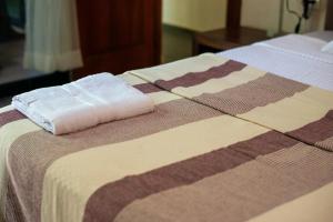 a bed with two towels on top of it at Lovely Villa 1-BR Villa Miguel in Chemuyil