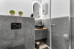 a small bathroom with a shower and a sink at 24-7 Living - Lüdinghausen Apartments in Lüdinghausen +72 photos