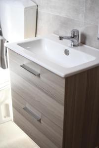 a bathroom with a white sink and a mirror at B&B L'Arcangelo in Cariati +11 photos