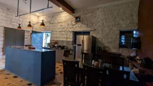 a large kitchen with a counter and a refrigerator at The Ark Farms in Denkanikottai