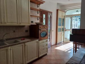 a kitchen with a sink and a washing machine at Max House in Marina di Cerveteri