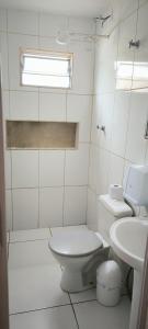a bathroom with a toilet and a sink at Apartamento Loft Confort 02 in Ponta Porã +20 photos