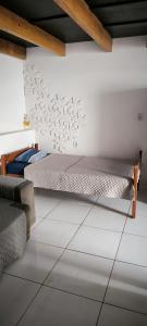 a bedroom with a bed in the corner of a room at Apartamento Loft Confort 02 in Ponta Porã