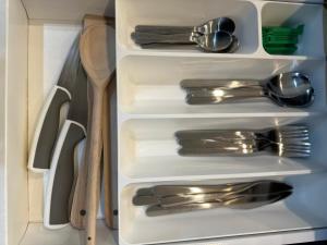 a white drawer with silver utensils in a kitchen at Charming 1 bed - near Marlow in Sands