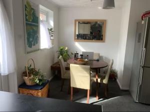 a kitchen with a table and chairs in a room at Bramley Fall Park Homestay in Horsforth