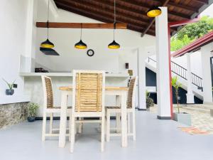 a kitchen and dining room with a table and chairs at Thara Inn Villa in Dickwella