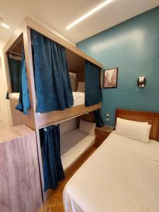 A bed or beds in a room at Minerva Grand Boutique