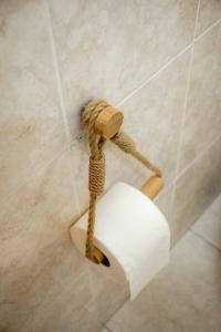 a roll of toilet paper hanging on a wall at Slowing Villas - Villa Âncora in Porto Santo