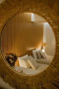 a reflection of a room with a couch in a mirror at Slowing Villas - Villa Âncora in Porto Santo +26 photos