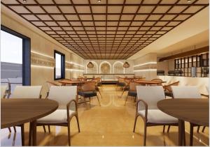 a restaurant with wooden tables and white chairs at Hotel La Premier in Hyderabad