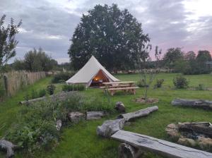 a tent with a picnic table in a field at Le Calibrochet - 24 Heures du Mans in Saint-Ouen-en-Belin +17 photos