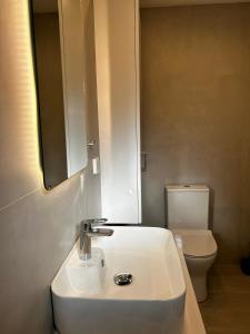 a bathroom with a white sink and a toilet at Stelios House in Pserimos in Psérimos +11 photos