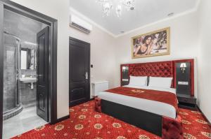 a bedroom with a large bed and a red rug at Arcadia City Apartments in Odesa