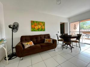 ウバトゥバにあるUbatuba UBA-HOME Apto 116のリビングルーム(ブラウンソファ、テーブル付)
