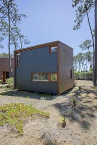 a small house is shown in a yard at Liiiving in Ofir - Seaside Pool Bungalow in Fão