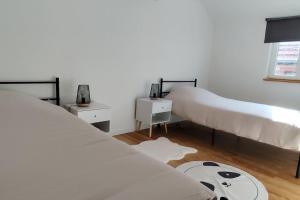a bedroom with three beds and a rug at Belle petite maison de 70m2 in Neuwiller-lès-Saverne +4 photos
