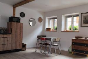 a dining room with a table and some chairs at Belle petite maison de 70m2 in Neuwiller-lès-Saverne