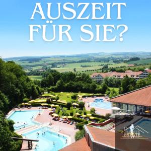 a view of a pool at a resort with the words austretturifuritz at FeWo 13 - Appartement im Rottalblick - Elegant und ruhig wohnen, Tiere willkommen, Bademantelgang zur Therme, TV, Boxspringbett, Balkon inkl Garage u Kurtaxe in Bad Griesbach