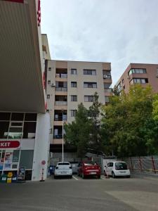 a parking lot with cars parked in front of a building at Casa Grazia in Balta Albă