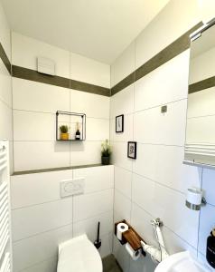a bathroom with a toilet and a sink at SmartStay Hotel Pumpengasse in Wolfsburg +15 photos