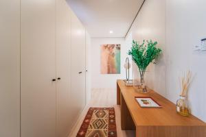 a home office with a wooden desk and white walls at Viana Vista Villa in Viana do Castelo +30 photos