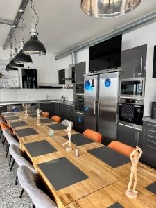 a kitchen with a long table with wooden mannequins on it at MEINpartments - Full service living in Wolfsburg +9 photos