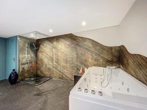 a bathroom with a bath tub and a shower at Les pièces du puzzle in Dunkerque