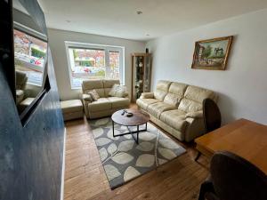 a living room with a couch and a table at Adina s House 5 Bedrooms in Rugeley
