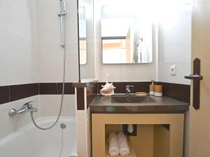 a bathroom with a sink and a shower and a tub at Apartment Village Cap Estérel - Le Village-80 by Interhome in Agay - Saint Raphael